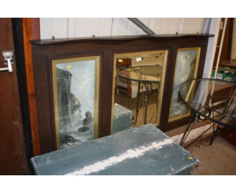 A large oak framed over mantel mirror inset with two painted panels 
