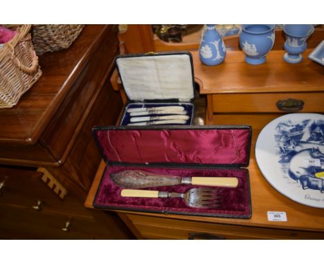 A silver plated serving fish knife and fork in fitted case; together with a set of butter knives with mother of pearl handles