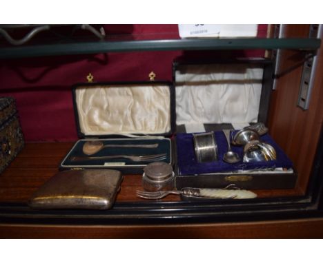 A quantity of mixed silver to include a cigarette case, serviette ring, an egg cup, sugar nips etc. 