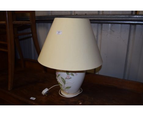 A large pottery floral decorated table lamp with shade 