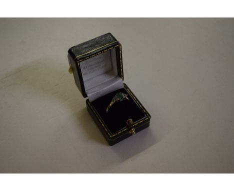 A silver and emerald set ring 