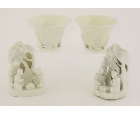 Two blanc de Chine libation cups,18th century, with flared rims, the sides moulded with magnolia or prunus, the branches form