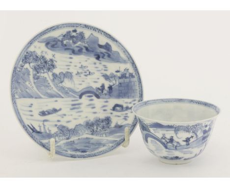 A blue and white Tea Bowl and Saucer, Kangxi (1662-1722), finely potted, each piece painted with travellers in a river landsc