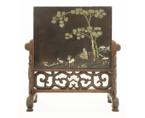 A lacquered table screen,17th/18th century, onlaid with a literatus seated under a bodhi tree, with a deer and crane, leaves 