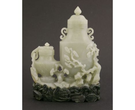 A jade double vase,20th century, carved with two bottles and covers surrounded by lingzhi trees coming from rocks, carved spi