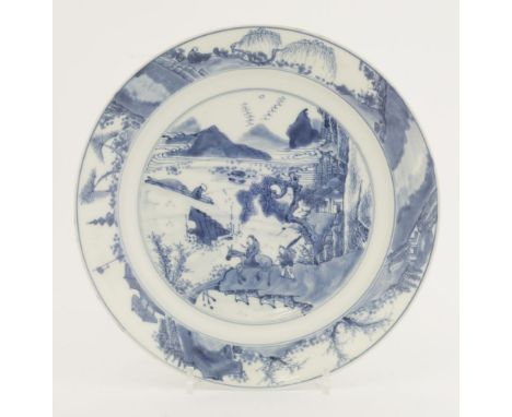 A blue and white large plate,Kangxi (1662-1722), painted in the centre with a man on a horse, with an attendant at his side, 