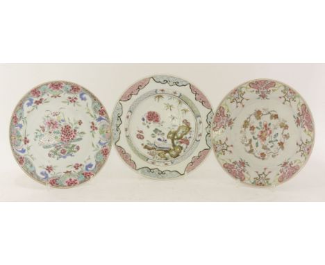 Three famille rose plates,18th century, painted with flowers within stylised borders, 22.9 to 22.5cm (3)Provenance: From the 