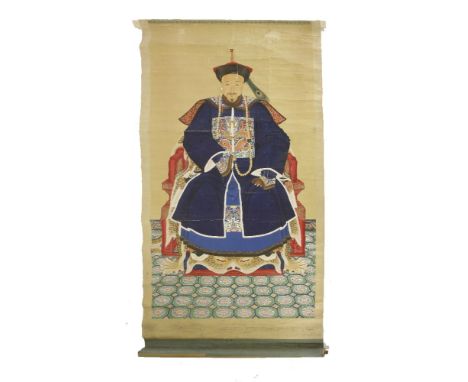 A large ancestor portrait painting,19th century, of an elderly man in dark blue winter court robes seated in a red lacquered 