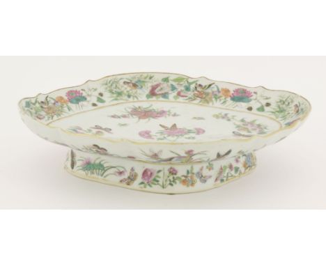 A Canton enamelled lozenge-shaped dish,first half of the 19th century, on low foot, painted with birds, peony, butterflies, l