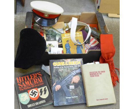 Military books, a peak cap, belt, sash, two glass bottles, etc.