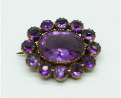 A 19th Century yellow metal and amethyst brooch