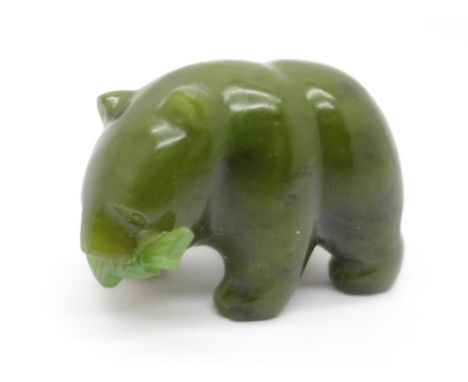 A carved nephrite jade bear with a fish