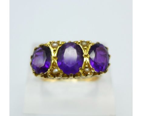 A 9ct gold and three stone amethyst and seed pearl ring, 6.7g, T