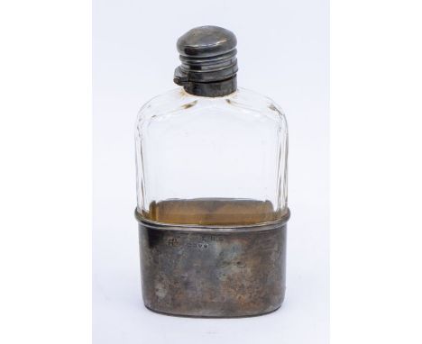 A Victorian silver mounted facet cut glass hip flask, the cover engraved with a crest, the base with initials, the silver bas