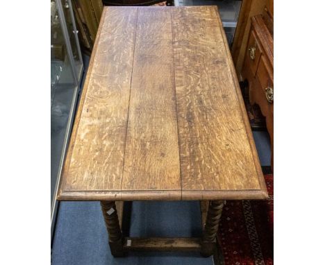 A late 17th Century oak table, oversailing triple planked rectangular top with moulded edge, above four bobbin turned legs, h