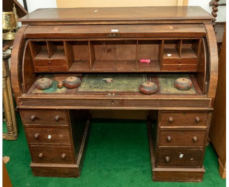 Roll top desk, fitted interior, with leather inserts, on twin pedestal base, as found