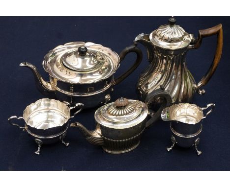 A George III style EPNS three piece tea service comprising teapot, milk jug and creamd jug, plain bodies with mid ribs on thr