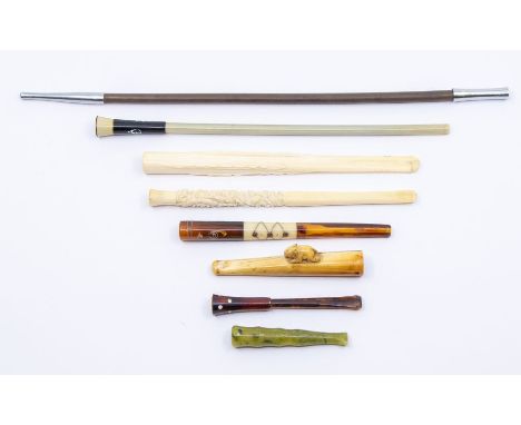 A collection of ivory and jade cigarette holders with amber and wooden, all circa 1920, 1930's and earlier