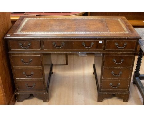 A reproduction pedestal desk in three parts, with brown writing pad