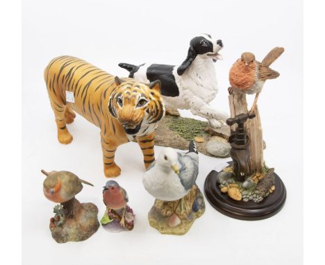 A collection of ceramics to include a Beswick tiger, birds by Royal Crown Derby, Country Artists and Royal Worcester along wi