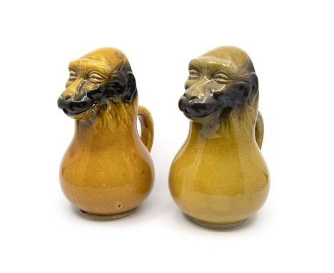 A pair of ceramic monkey jugs