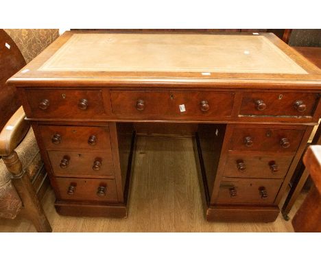 A Victorian twin pedestal kneehole desk, fitted nine drawers, leather inset top