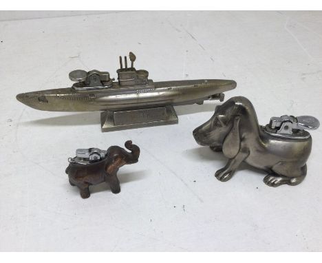 Three early to late 20th Century cast desk lighters, including U-581 U Boat, elephant and beagle dog desk lighters