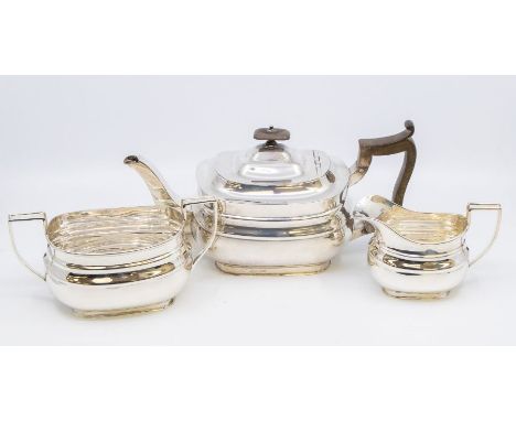 A Georgian style three piece silver tea service comprising teapot, sugar bowl and milk jug, the teapot with fruitwood handle 
