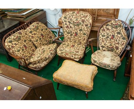 An Ercol spindle back two seater armchair with two matching armchairs and pouffe with tapestry seats and backs