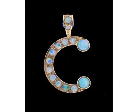 An opal and 9ct gold initial 'C' pendant, set throughout with round opals, comprising smaller grain set round opals with larg