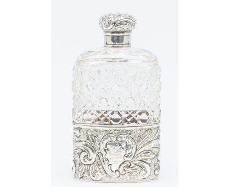 A Victorian silver mounted hob nail cut glass flask, the detachable base chased with flowers and foliage, the central cartouc