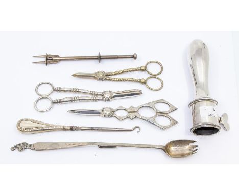 A collection of silver plate to include: a 19th Century style carver's companion, three various grape scissors, an elongated 