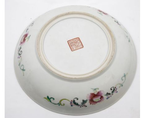 A Chinese polychrome enamel charger, profusely decorated with multi coloured Chrysanthemums and other flowers, the underside 
