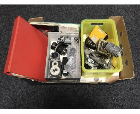 A box of cameras and lenses, camera parts, Zeiss books 