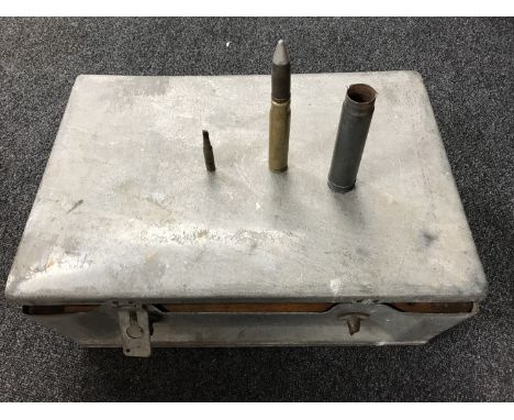 A metal military ammunition case containing shells 