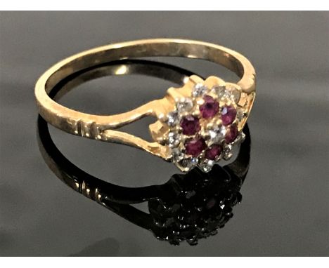 A 9ct gold diamond and ruby cluster ring, size M.