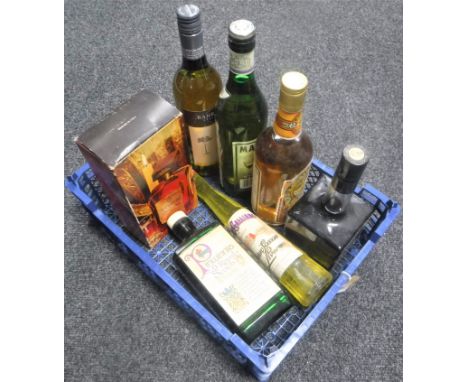 A basket of seven bottles of alcohol - bottle of Pinie Royal Scotch whiskey, Amaretto etc 