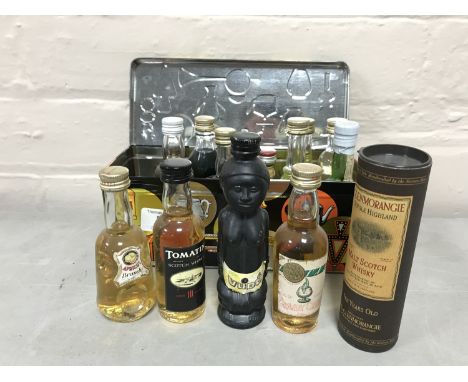 A tin containing a quantity of miniature alcohols including Glenmorangie Malt Scotch etc