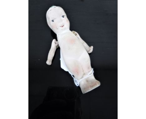 A WWI ceramic 'Fums-Up' doll. (Fums-up dolls were given to soldiers of the First World War as good luck charms).