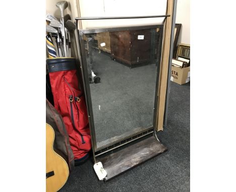 A chrome framed mirror with shelf 