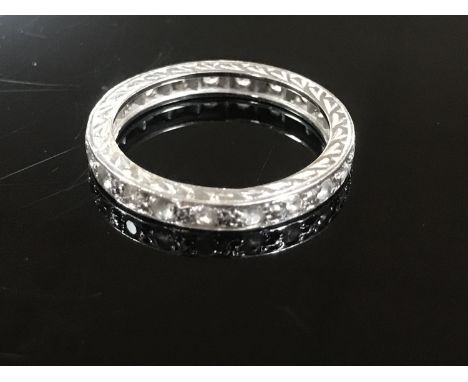 A white metal diamond full eternity ring, size K/L.