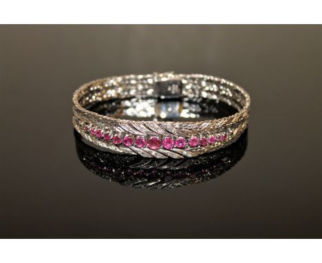 A fine quality ruby and diamond bracelet in 18ct white gold, 52g.