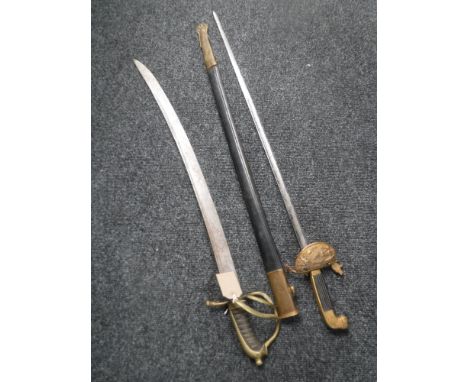 A naval style sword in sheath and an Indian sword  CONDITION REPORT: These are both reproductions. The straight sword has a 7