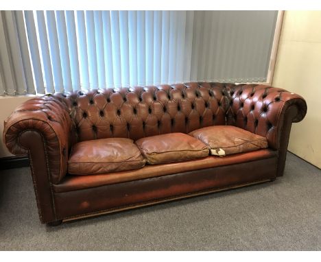 A brown button leather Chesterfield three seater settee 