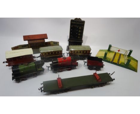 A collection of Hornby O Gauge tinplate railway including two 0-4-0 locos, four  items of rolling stock, Central Station buil