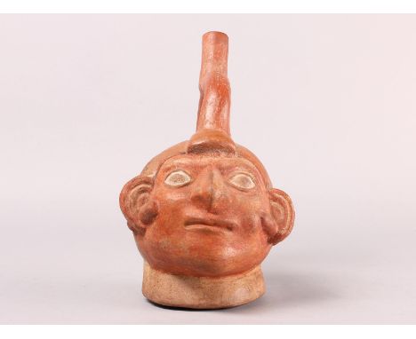 Peru, Moche, a stirrup-spout portrait vessel, 50-800 AD with ear spools (restored) h. 24,5 cm. Provenance:Private collection 