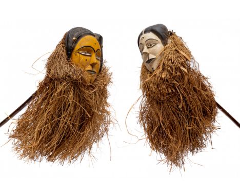 India, two puppet masks on stick with plant fibre skirts. h. ca. 56 cm. [2]