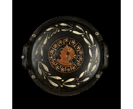 APULIAN RED FIGURE PATERA  SOUTHERN ITALY, C. 340-320 B.C. painted ceramic, with painted knob handles, the tondo decorated wi