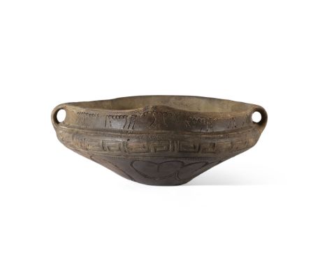 VINCA VESSEL  BALKANS, 5TH MILLENIUM B.C. fired and impressed terracotta, the round and squat vessel sits on a flat base, cur