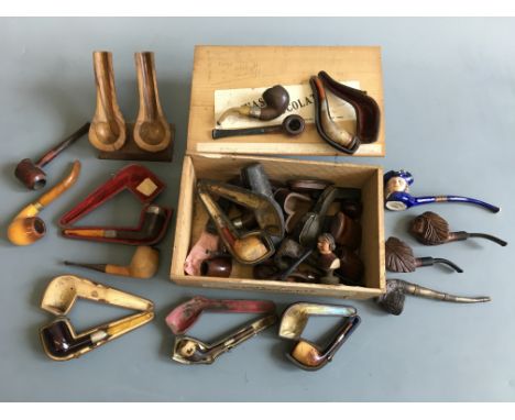 A box containing various smoking pipes, some cased, pipe holders, boxes, etc. IMPORTANT: Online viewing and bidding only. No 